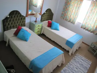 a bedroom with two beds with blue and red pillows at Highview Villa in Lagos