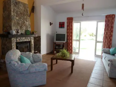 a living room with two chairs and a fireplace at Highview Villa in Lagos