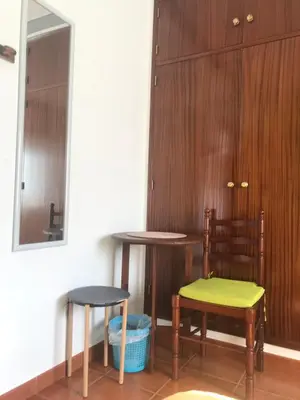 two tables and two stools in a room at Casa Da Estela in Carrapateira