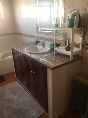 a bathroom with a sink and a mirror at Casa Da Estela in Carrapateira