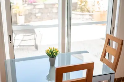 a glass table with a vase of flowers on it at Villa São Tiago by Amazing Madeira in Funchal