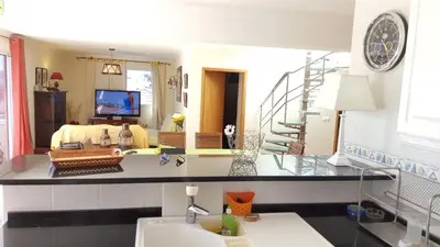 a room with a sink and a living room at Sotavento Guest House in Porto Santo