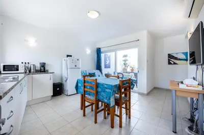 a kitchen and dining room with a table and chairs at Casa Da Paz in Salema