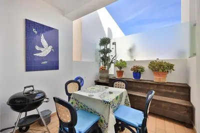 a dining room with a table and chairs at Casa Da Paz in Salema
