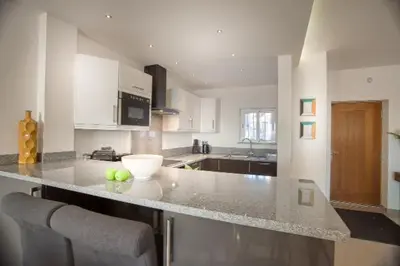 a kitchen with a counter with a bowl of apples on it at Waterside Village in Luz