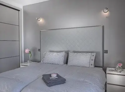 a bedroom with a large bed with a tray on it at Waterside Village in Luz
