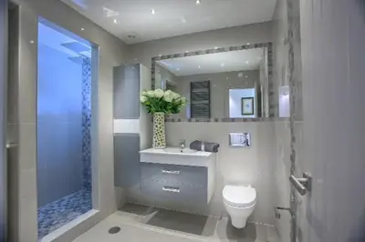 a bathroom with a toilet and a sink and a shower at Waterside Village in Luz
