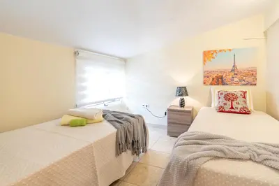 a bedroom with two beds and a window at Apartamento Teixeira in Arco da Calheta