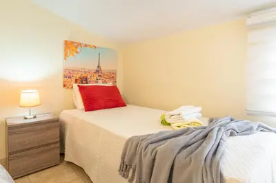 a bedroom with a bed and a painting on the wall at Apartamento Teixeira in Arco da Calheta