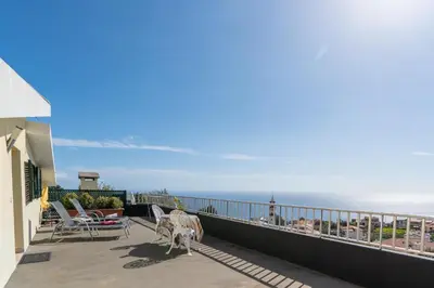 a balcony with chairs and a view of the ocean at Apartamento Teixeira in Arco da Calheta