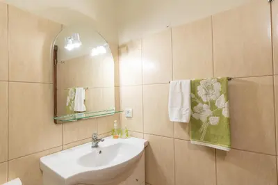 a bathroom with a sink and a mirror at Apartamento Teixeira in Arco da Calheta