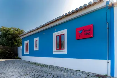 a blue building with a sign that reads just kidding at Cercas Velhas in Sagres