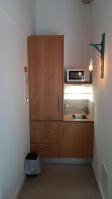 a small kitchen with a sink and a microwave at Cercas Velhas in Sagres