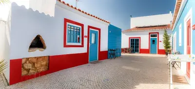 a row of colorful houses in a street at Cercas Velhas in Sagres