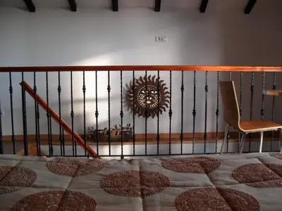 a bedroom with a bed and a chair and a mirror at Fazenda do Sousinha in Funchal