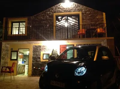 a car parked in front of a house at night at Fazenda do Sousinha in Funchal