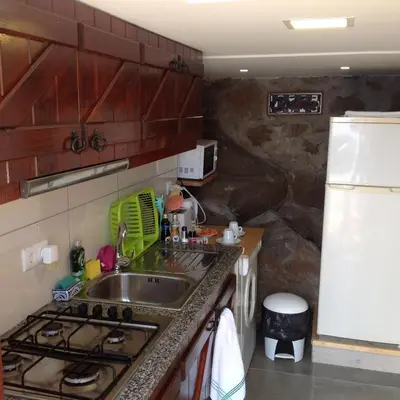 a kitchen with a sink and a stove at Fazenda do Sousinha in Funchal
