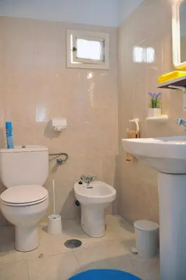a bathroom with a toilet and a sink at 16 Porto Santo Apartments in Porto Santo