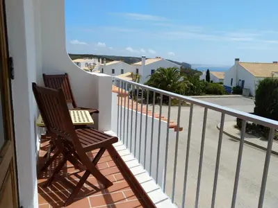 two chairs on a balcony with a view of the ocean at Casa dos Pinheiros in Praia da Arrifana
