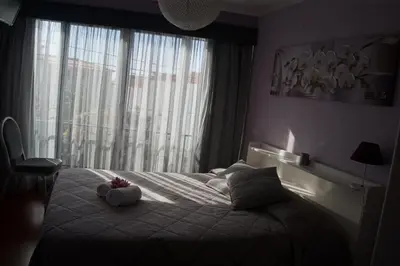 a bedroom with a bed with two stuffed animals on it at Casa Violeta in Funchal
