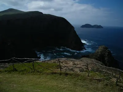 a fence on top of a cliff near the ocean at INATEL Porto Santo in Porto Santo