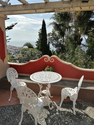 a table and chairs on a patio with a view at A Casa Do Caseiro in Funchal