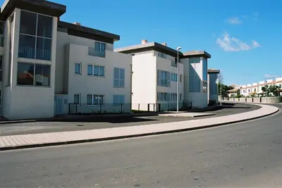 an empty street in front of a building at Paraiso Dourado in Porto Santo