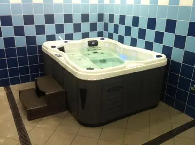 a bath tub in a bathroom with a chair at Paraiso Dourado in Porto Santo