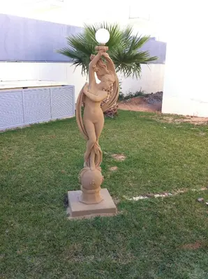 a statue of a woman with a ball on its head at Paraiso Dourado in Porto Santo