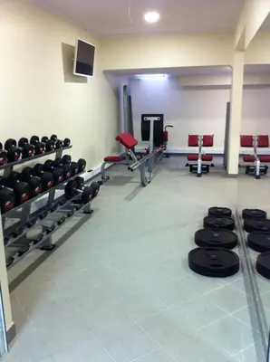 a gym with rows of dumbbells in a room at Paraiso Dourado in Porto Santo