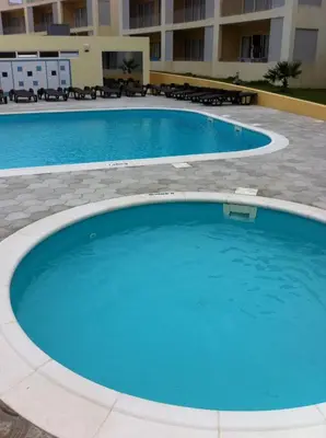 a large pool with blue water in a building at Paraiso Dourado in Porto Santo