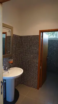 a bathroom with a sink and a mirror at Villa Babel in Garajau