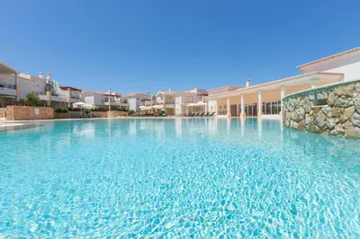 a swimming pool in a villa with blue water at NAU Salema Beach Village in Salema