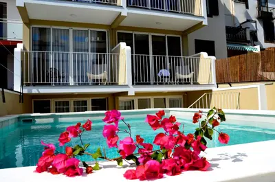a bedroom with a white bed and a balcony at Vila Toca in Funchal