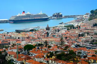 a cruise ship in the water next to a city at Vila Toca in Funchal