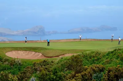 a group of people playing golf on a golf course at Vila Toca in Funchal