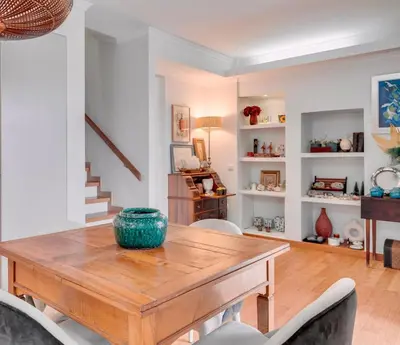 a dining room with a wooden table and chairs at Casa da Rochinha com piscina privada in Funchal