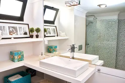 a white bathroom with a sink and a shower at Casa da Rochinha com piscina privada in Funchal