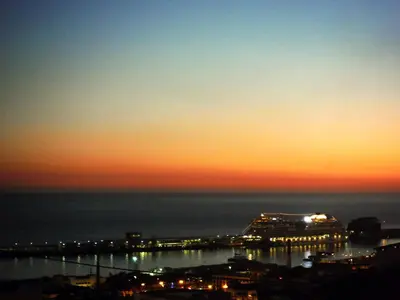 a cruise ship in the ocean at sunset at Casa da Rochinha com piscina privada in Funchal