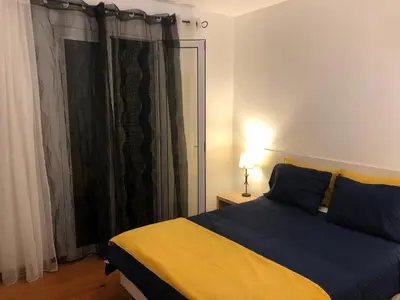 a bedroom with a blue and yellow bed and a window at Apartment Alameda with Sea View in Machico