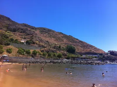 a group of people in the water at a beach at Apartment Alameda with Sea View in Machico