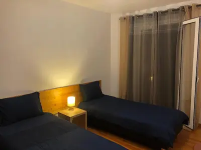 a bedroom with two beds and a table with a lamp at Apartment Alameda with Sea View in Machico