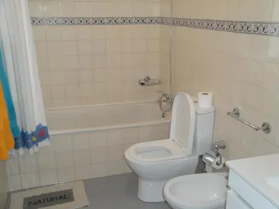 a bathroom with a toilet and a tub and a sink at Apartment Alameda with Sea View in Machico