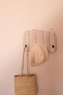 a hat and a purse hanging on a wall at Utopia in Aljezur