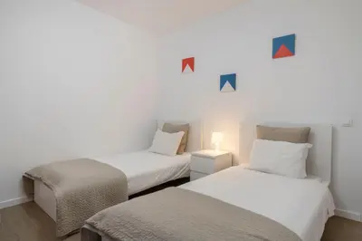 two beds in a room with arrows on the wall at Casa da Maresia by An Island Apart in Porto Santo