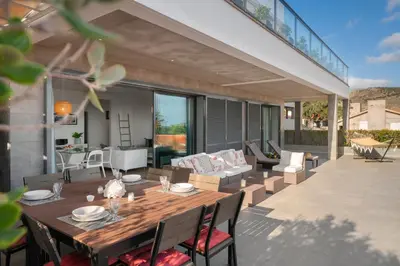 a patio with a wooden table and chairs at Casa da Maresia by An Island Apart in Porto Santo