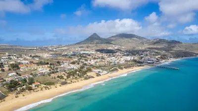 an aerial view of a beach with mountains in the background at Casa da Maresia by An Island Apart in Porto Santo