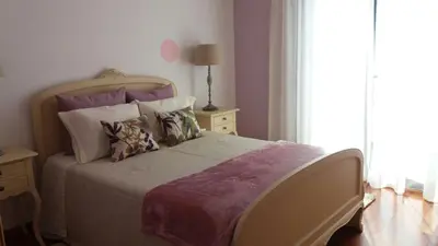 a bedroom with a large bed with pillows at The best sea view in Madeira - Casa Farol in Fajã da Ovelha