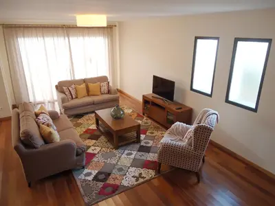 a living room with a couch and a tv at The best sea view in Madeira - Casa Farol in Fajã da Ovelha