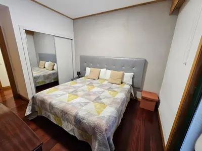 a small bedroom with a bed and a mirror at Ilheus 1 in Funchal